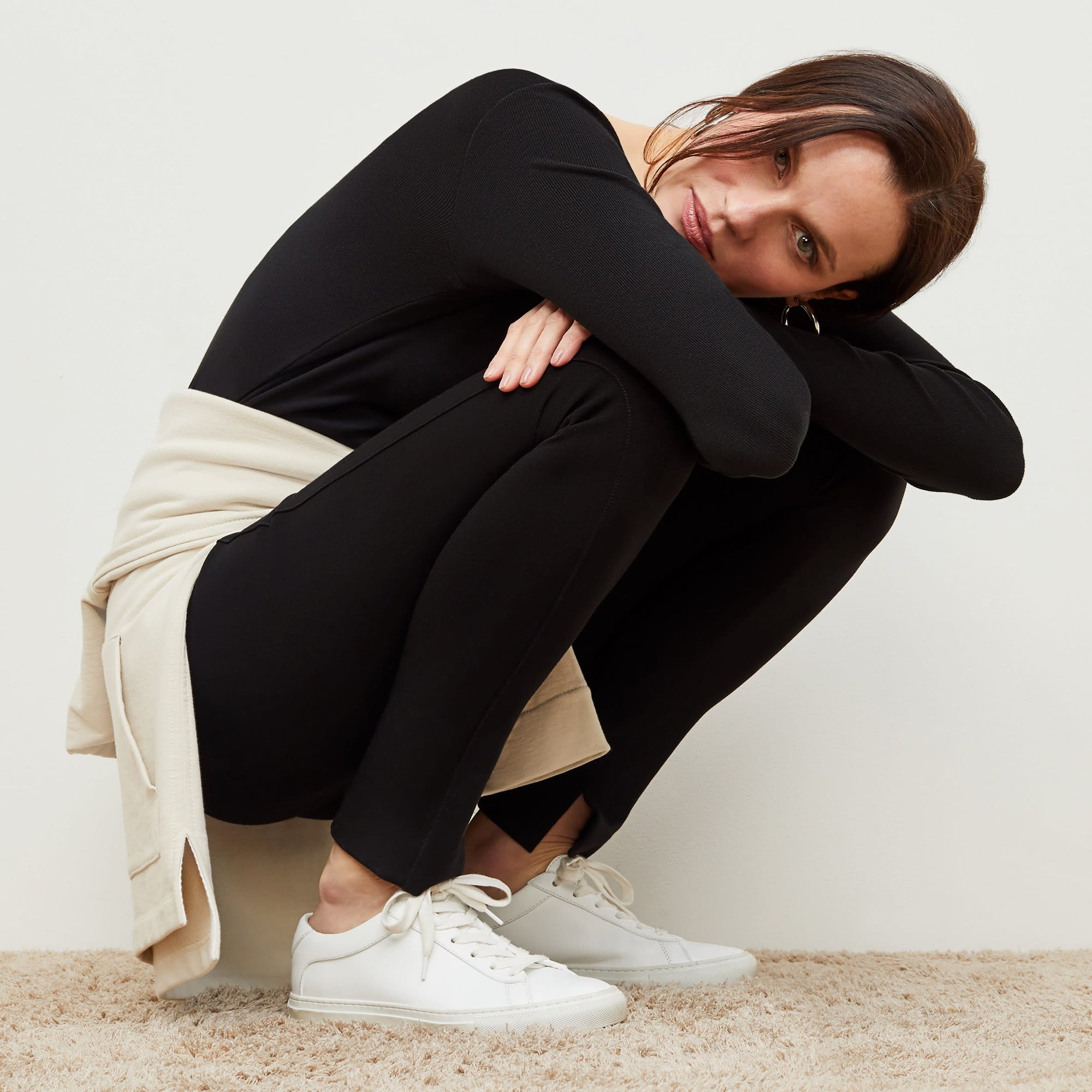 Detail image of a woman standing wearing the stella legging in black | Exclude