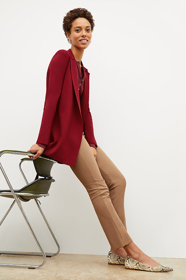 Front image of a woman sitting wearing the Foster Pant—Everstretch in Saddle | Exclude